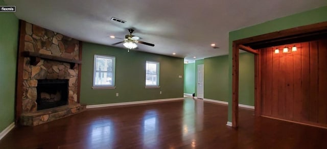 unfurnished living room featuring ceiling fan, dark hardwood / wood-style flooring, and a fireplace