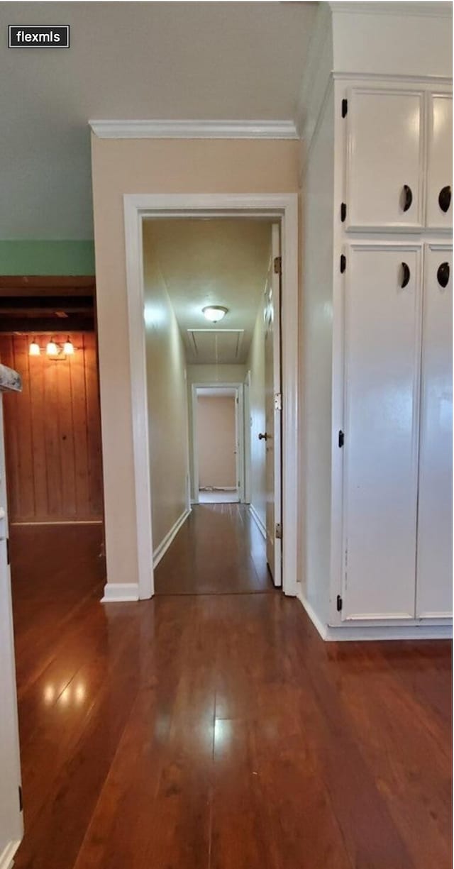 hall with dark hardwood / wood-style floors and crown molding