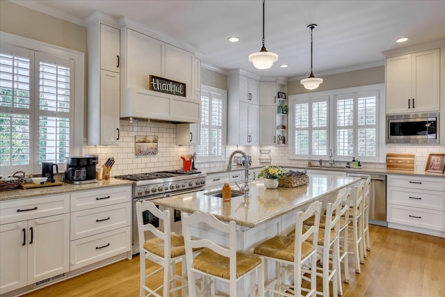 kitchen with white cabinets, a sink, and appliances with stainless steel finishes