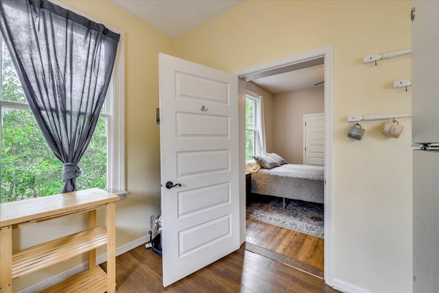 bedroom featuring dark wood-type flooring and baseboards