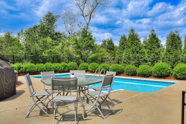 view of swimming pool with a fenced in pool, a patio area, outdoor dining area, and a fenced backyard