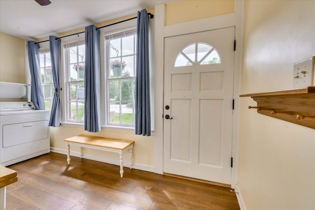 entryway with washer / clothes dryer, baseboards, plenty of natural light, and wood finished floors