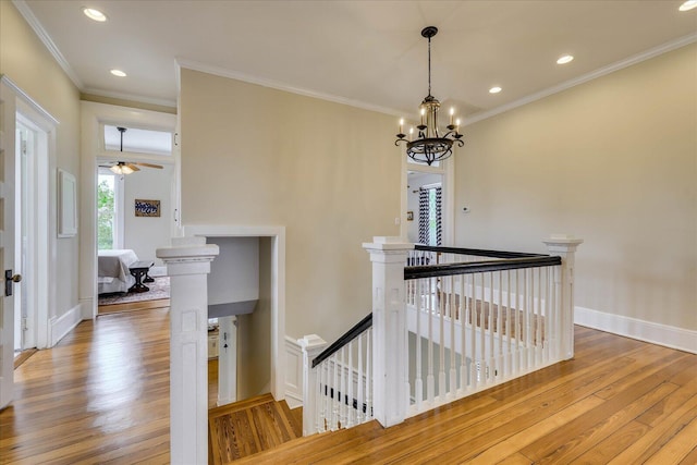 staircase with crown molding, baseboards, recessed lighting, and wood finished floors