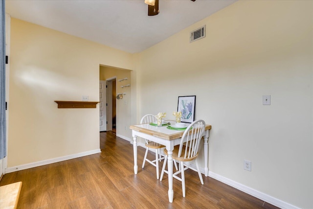 dining room with baseboards, a ceiling fan, and wood finished floors