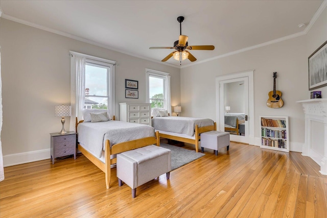 bedroom with baseboards, light wood-type flooring, ornamental molding, and a ceiling fan