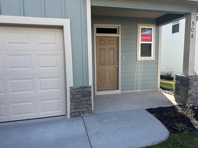 doorway to property featuring a garage