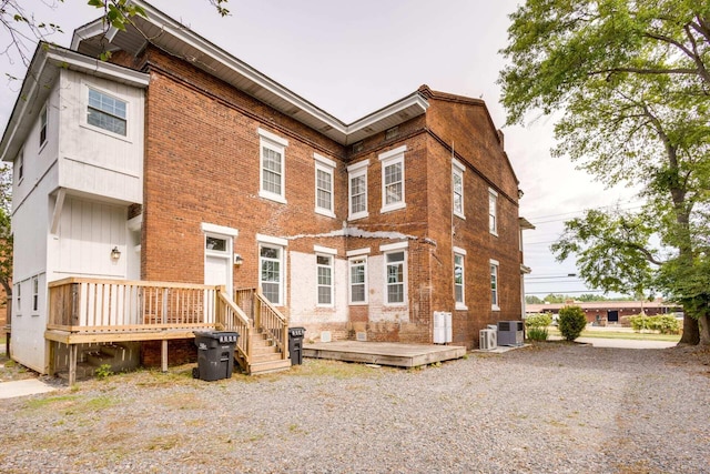 rear view of house featuring cooling unit and a deck