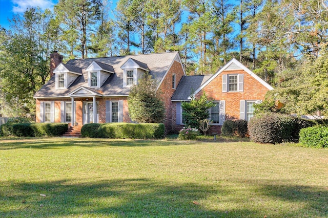 cape cod home featuring a front lawn