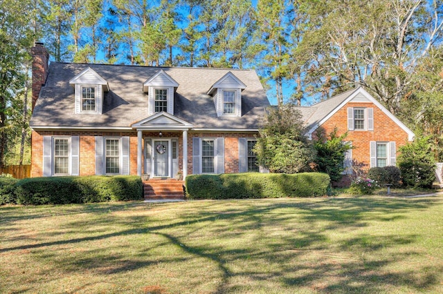 cape cod-style house featuring a front yard