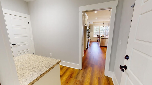 151 Cypress Dr, Mccormick, SC 29835 - corridor with wood-type flooring and a chandelier