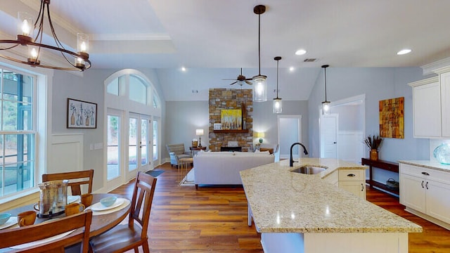 151 Cypress Dr, Mccormick, SC 29835 - kitchen featuring light stone counters, decorative light fixtures, sink, and a center island with sink