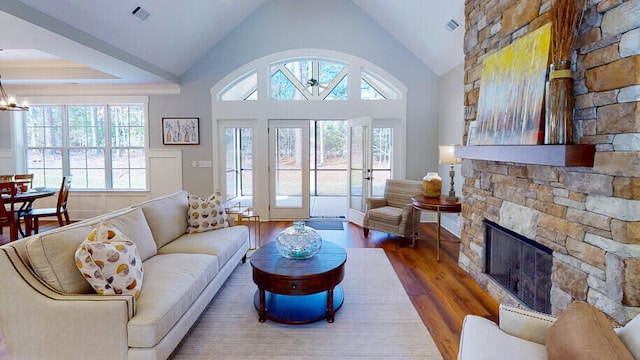 151 Cypress Dr, Mccormick, SC 29835 - living room featuring hardwood / wood-style flooring, high vaulted ceiling, a fireplace, and an inviting chandelier