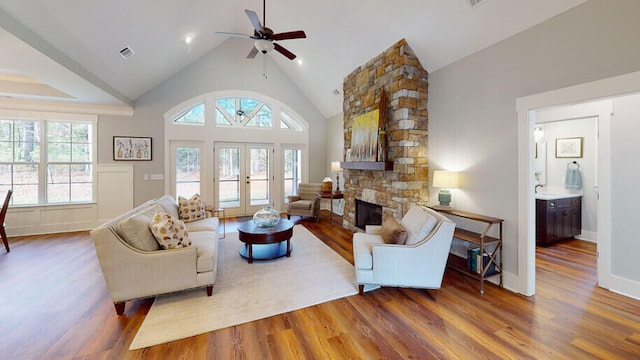 151 Cypress Dr, Mccormick, SC 29835 - living room with french doors, a stone fireplace, dark hardwood / wood-style flooring, and a wealth of natural light