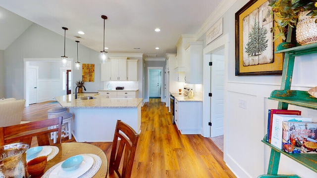 151 Cypress Dr, Mccormick, SC 29835 - kitchen featuring sink, hanging light fixtures, light stone countertops, white cabinets, and a center island with sink