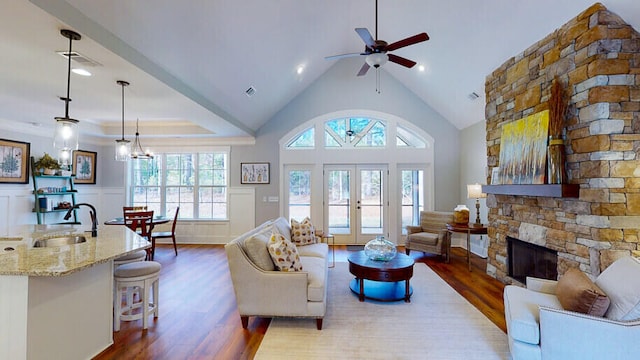 151 Cypress Dr, Mccormick, SC 29835 - living room with high vaulted ceiling, a fireplace, sink, dark wood-type flooring, and french doors