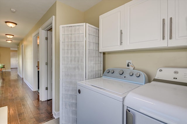 2010 Battle, Augusta, GA 30904 - washroom featuring washing machine and clothes dryer, cabinet space, and wood finished floors