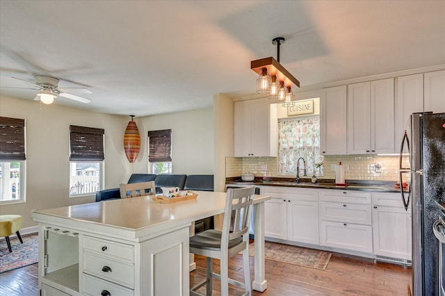 2010 Battle, Augusta, GA 30904 - kitchen with freestanding refrigerator, light wood finished floors, and tasteful backsplash