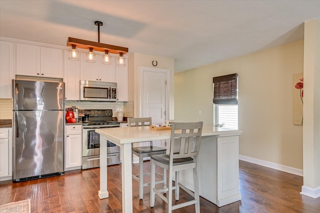2010 Battle, Augusta, GA 30904 - kitchen with appliances with stainless steel finishes, dark wood-style floors, tasteful backsplash, and white cabinets