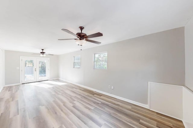 spare room featuring french doors, ceiling fan, and light hardwood / wood-style floors