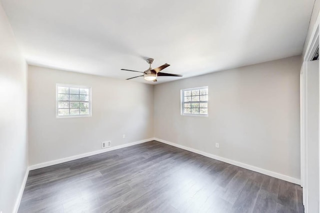 unfurnished room with plenty of natural light, dark hardwood / wood-style floors, and ceiling fan