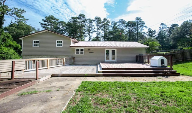 rear view of house featuring french doors, a yard, and a wooden deck