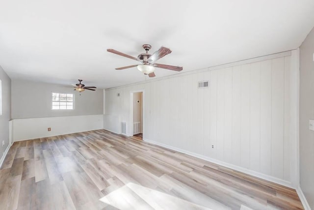 empty room with light hardwood / wood-style floors and ceiling fan