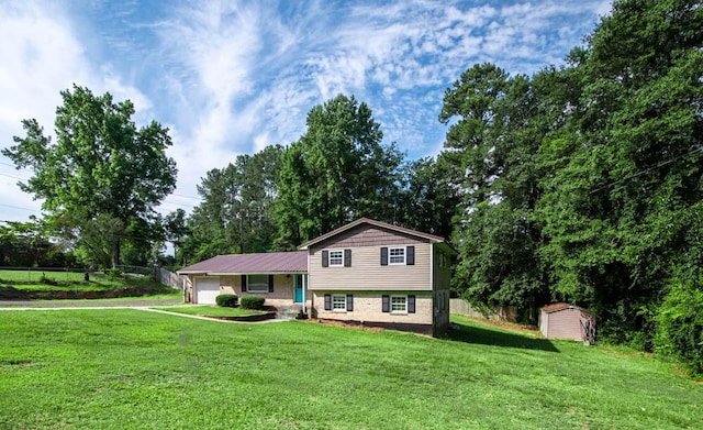 split level home with a garage, a storage unit, and a front lawn