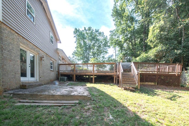 view of yard with a wooden deck and central AC unit