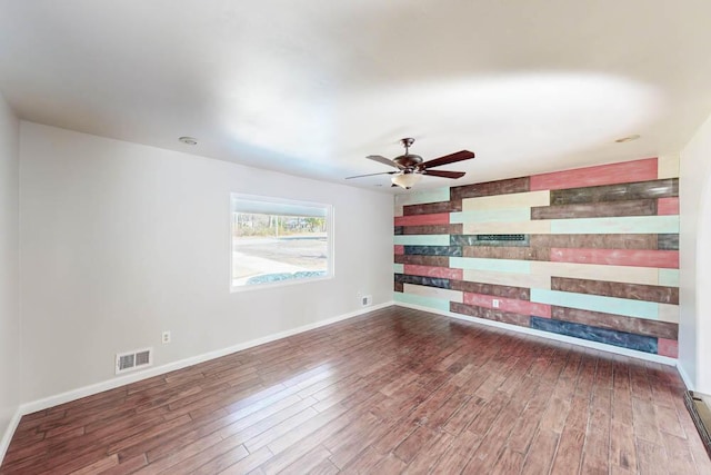 unfurnished room with ceiling fan and dark hardwood / wood-style flooring