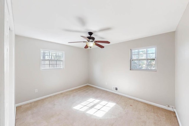 unfurnished room with ceiling fan and light colored carpet