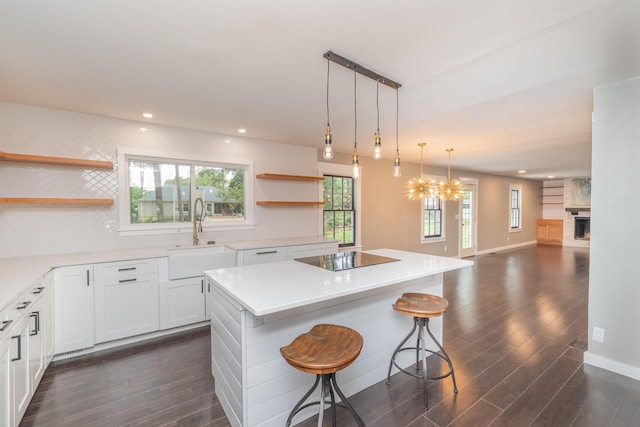 1 Partridge Ct, Aiken, SC 29803 - kitchen featuring open shelves, black electric cooktop, dark wood-style flooring, a kitchen island, and recessed lighting