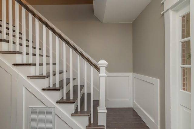 1 Partridge Ct, Aiken, SC 29803 - stairway with wood finished floors, wainscoting, and a decorative wall