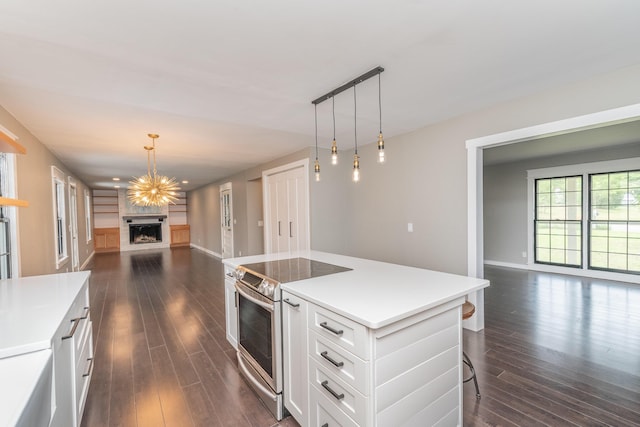 1 Partridge Ct, Aiken, SC 29803 - kitchen with stainless steel electric range, open floor plan, a fireplace, white cabinetry, and dark wood-style floors