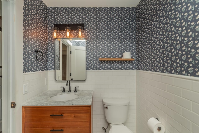 1 Partridge Ct, Aiken, SC 29803 - bathroom with wallpapered walls, wainscoting, tile walls, and vanity
