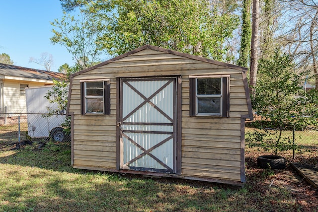 view of shed with fence