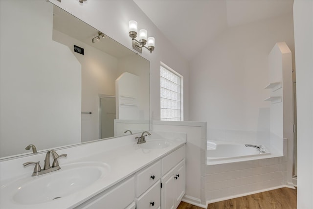 full bathroom with wood finished floors, double vanity, a bath, a shower with door, and vaulted ceiling