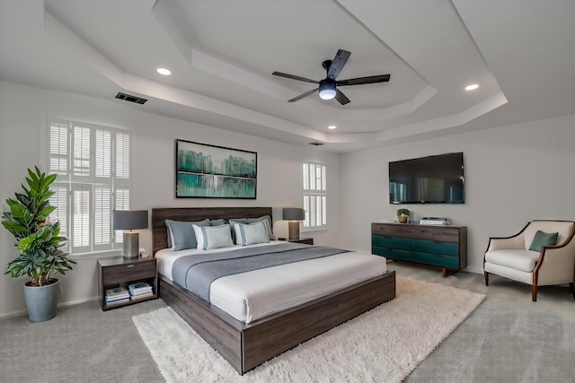 bedroom with a raised ceiling, carpet, recessed lighting, baseboards, and a ceiling fan