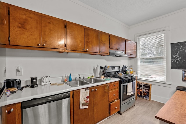 kitchen with sink, crown molding, a textured ceiling, and appliances with stainless steel finishes