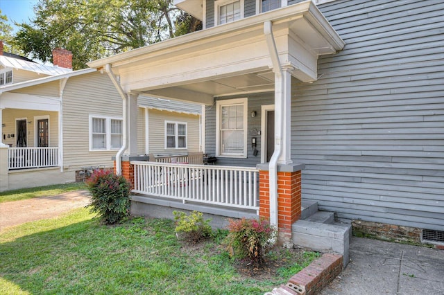 view of exterior entry featuring a porch