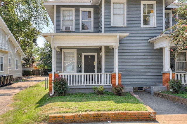 view of front of home with cooling unit and a front yard