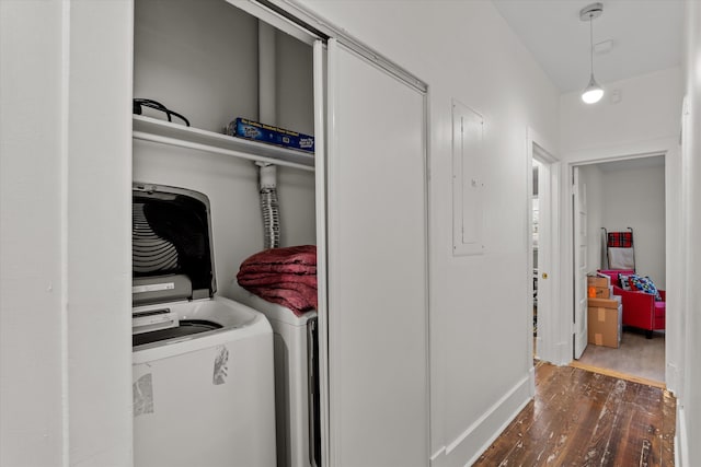 laundry area featuring dark hardwood / wood-style flooring, washing machine and dryer, and electric panel