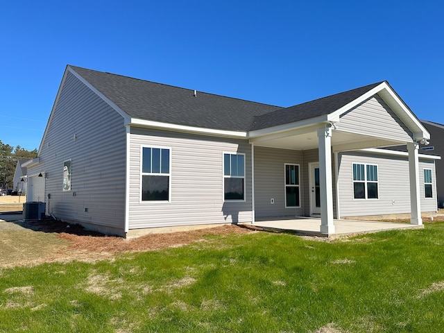 back of house with a patio, a yard, and central AC unit