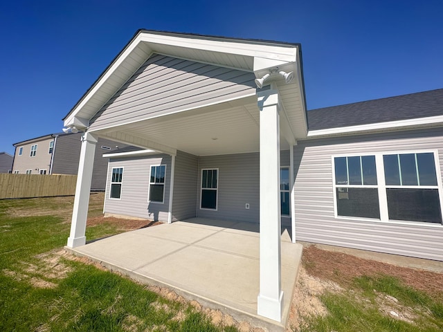 rear view of property with a patio area and a lawn