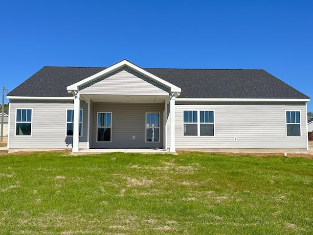 back of house with a yard and a patio