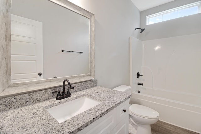 full bathroom featuring vanity, wood-type flooring, bathing tub / shower combination, and toilet