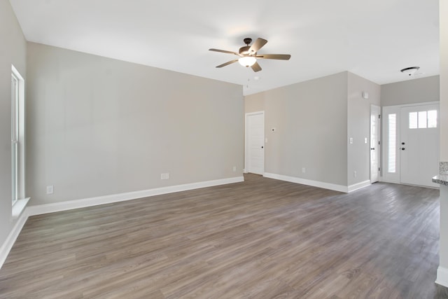 interior space with dark wood-type flooring and ceiling fan