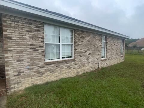 view of side of home featuring a yard