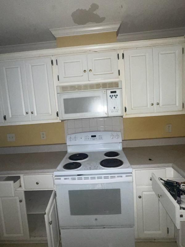 kitchen with white cabinetry, white appliances, and ornamental molding