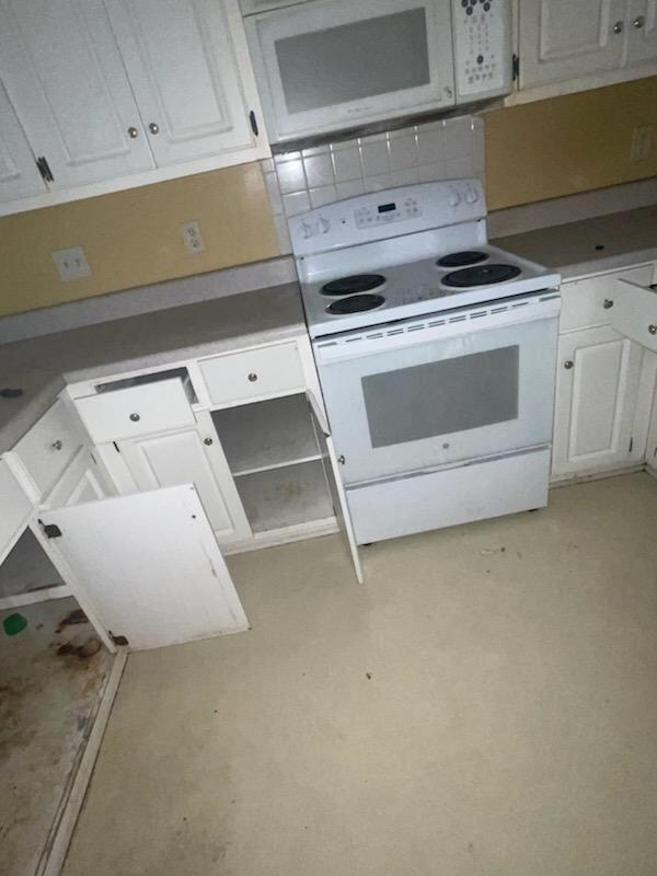 kitchen with white cabinets and white appliances