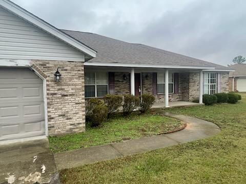 view of front of house with a front lawn and a garage